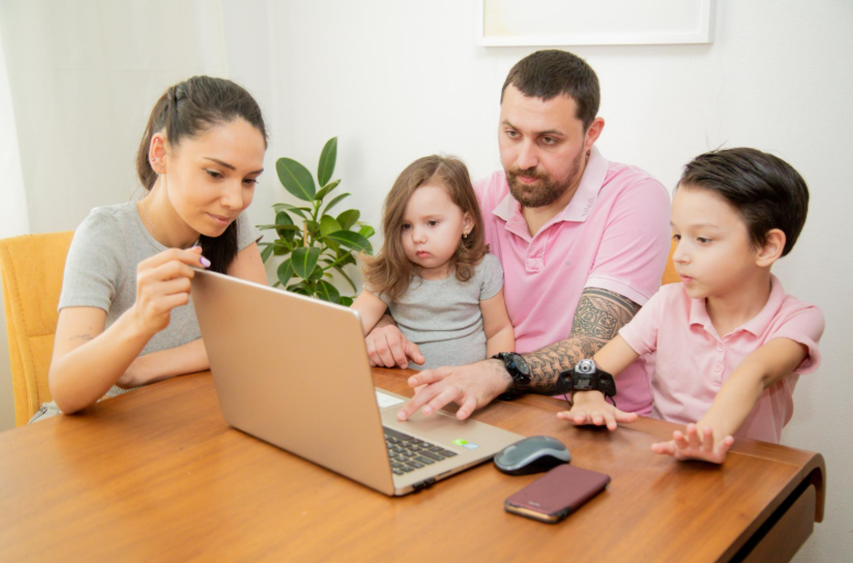 family using educationbeing com together on a laptop showing parent portal and student progress
